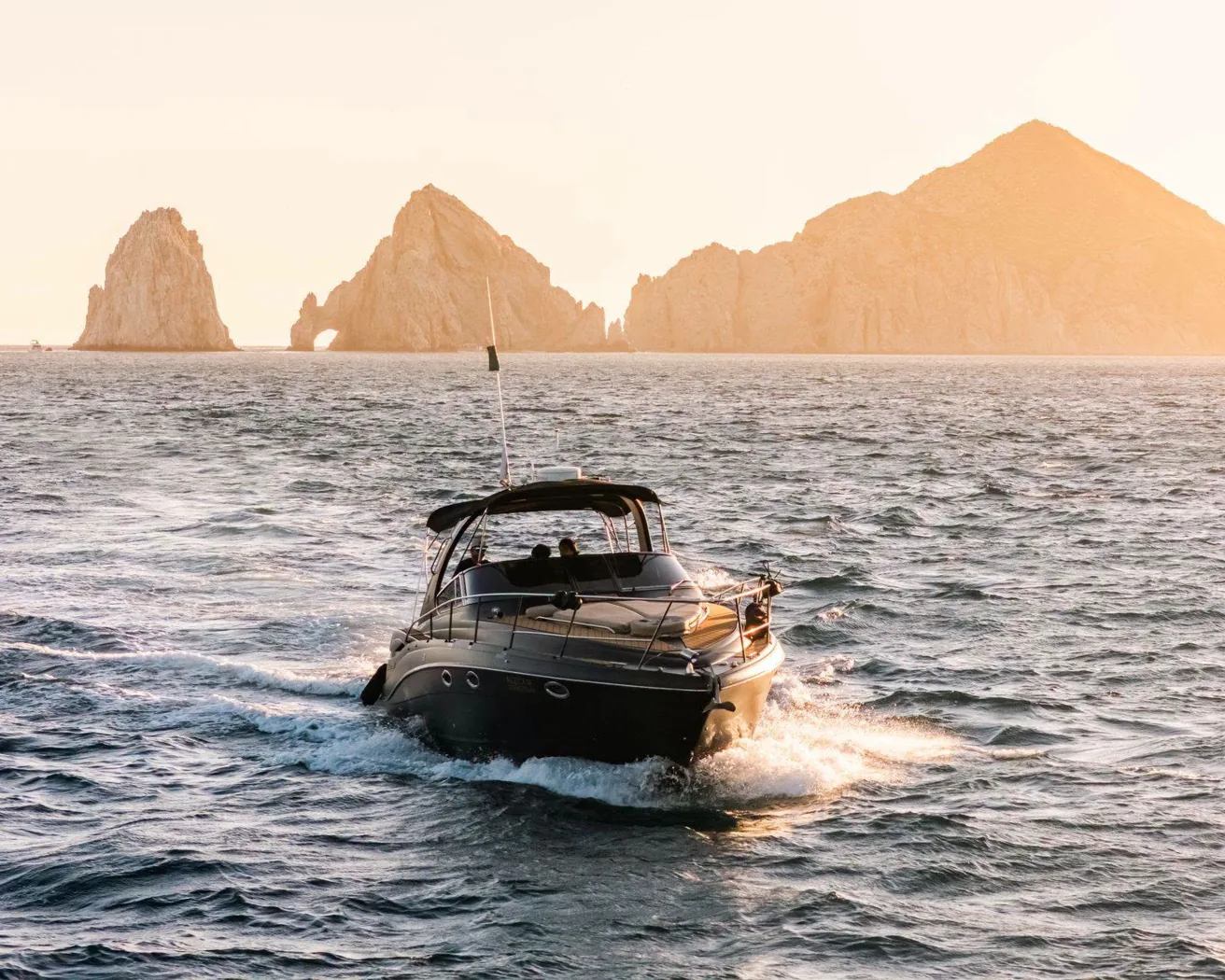 Embarcación y paisaje rocoso de Los Cabos al atardecer